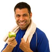 A happy mid-adult man eating an apple after working out.
